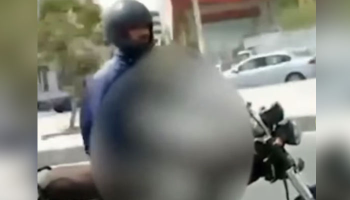 A biker exposes himself to female students in this undated still taken from a video. — Instagram/ salaam_pakistan