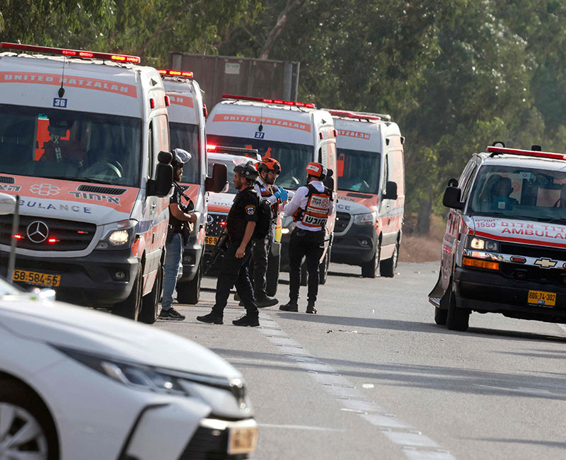 Israeli rescue teams wait next to ambulances parked just outside the southern city of Sderot to evacuate the wounded on October 7, 2023. — AFP