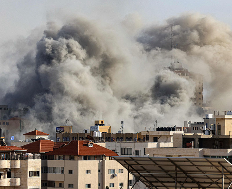 Smoke plumes rise over Gaza City on October 7, 2023 during Israeli air strikes. — AFP