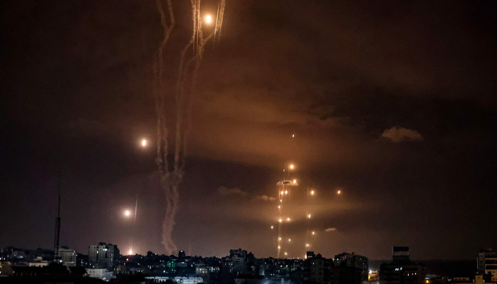 Rockets fired from Gaza City are intercepted by the Israeli Iron Dome defence missile system on October 7, 2023. — AFP