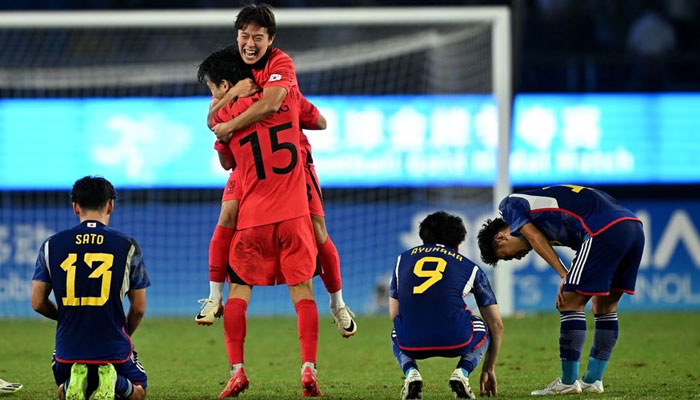 South Koreas players celebrate after winning the match as Japans players react near them during the 2022 Asian Games at Huanglong Sports Centre Stadium, Hangzhou, China on October 7, 2023. — Reuters