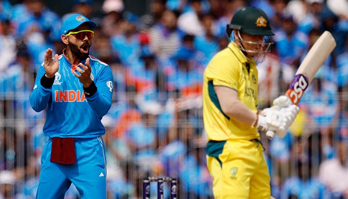 Indias Virat Kohli reacts as Australias David Warner looks on during the match at the MA Chidambaram Stadium in Chennai, India, on October 8, 2023. — Reuters