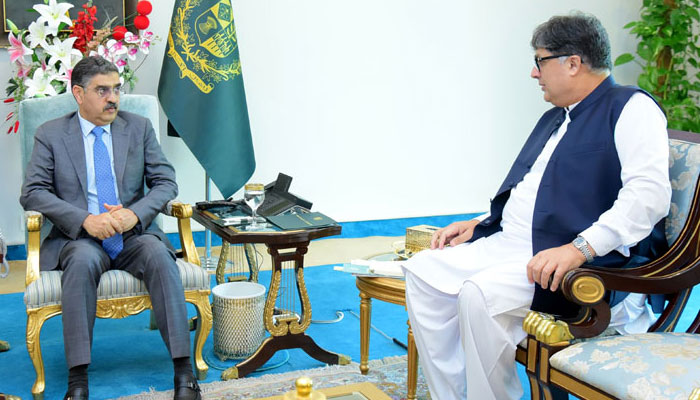 Minister for Privatization Fawad Hasan Fawad (r) meets Caretaker Prime Minister Anwar-ul-Haq Kaka in Islamabad on October 9, 2023. — Radio Pakistan