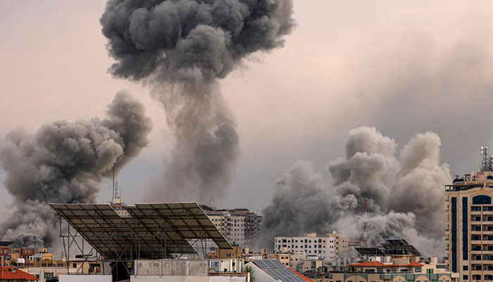 TOPSHOT - A plume of smoke rises in the sky of Gaza City during an Israeli airstrike on October 9, 2023.—AFP