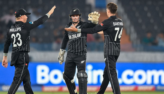 New Zealand’s Mitchell Santner (R) celebrates with teammates after taking the wicket of Netherlands´ Colin Ackermann during the 2023 ICC Men´s Cricket World Cup one-day international (ODI) match between New Zealand and Netherlands at the Rajiv Gandhi International Stadium in Hyderabad on October 9, 2023. – AFP