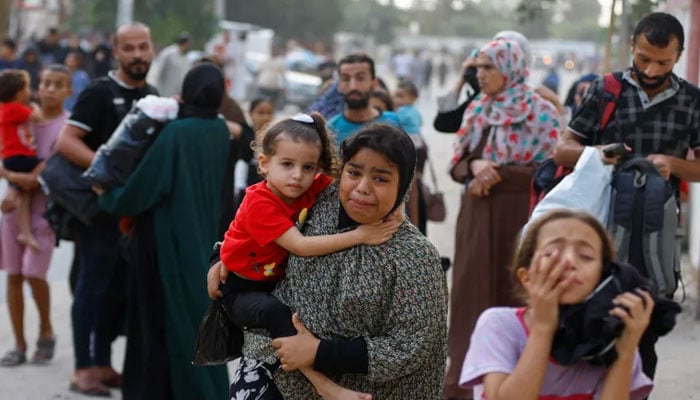 Residents flee Khan Younis in the southern Gaza Strip as Israel’s air bombardment continues on October 9, 2023. Reuters