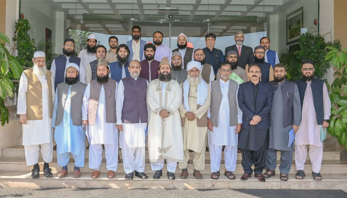 PTA officials and Pakistans religious scholars pose for a picture at PTA headquarters, Islamabad. — PTA