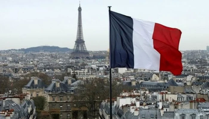 The French flag flutters in the wind in Paris. — AFP/File