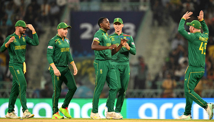 South Africa´s Kagiso Rabada (C) celebrates with teammates after taking the wicket of Australia´s Josh Inglis during the 2023 ICC Men´s Cricket World Cup one-day international (ODI) match between Australia and South Africa at the Ekana Cricket Stadium in Lucknow on October 12, 2023 — AFP