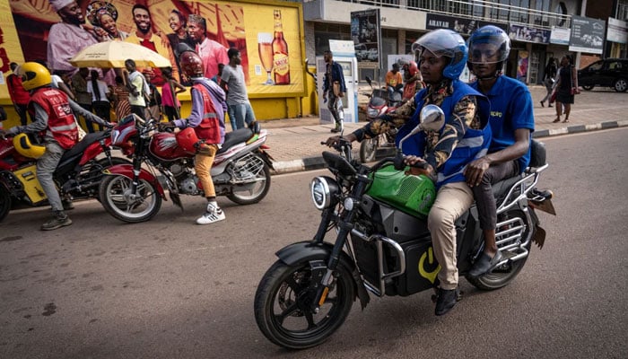 Locals riding Spiros electric motorcycles in the streets of a city in Kenya. — CNN/AFP/File