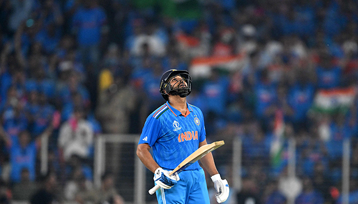 Indias captain Rohit Sharma celebrates after scoring a half-century during the ICC Mens Cricket World Cup match between India and Pakistan at the Narendra Modi Stadium in Ahmedabad on October 14, 2023. — AFP