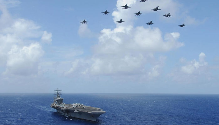 In this image released by the US Department of Defense, F/A-18C Hornets fly over the USS Dwight D. Eisenhower aircraft carrier on July 2, 2013. AFP/File