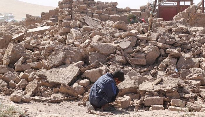 A boy cries as he sits next to debris in the aftermath of an earthquake in the district of Zinda Jan, in Herat, Afghanistan, October 8. — Reuters