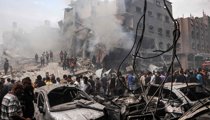 Palestinians search for survivors after an Israeli airstrike on buildings in the refugee camp of Jabalia in the Gaza Strip on October 9, 2023. — AFP