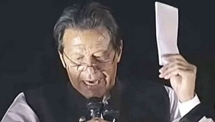In this file photo, former prime minister Imran Khan holds what he claimed was a cipher which is proof of a “foreign conspiracy” to oust him from office during a rally in Islamabad in March 2022. — X/@MuzamilChang