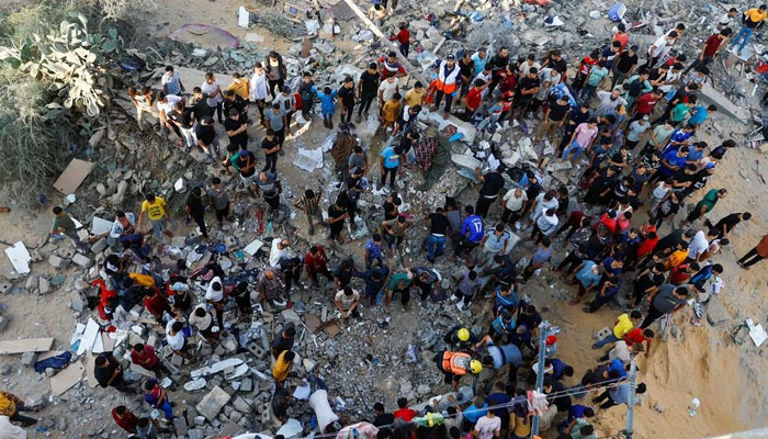 Palestinians search for casualties under the rubble of a house destroyed in Israeli strikes in Khan Younis in the southern Gaza Strip October 16, 2023. — Reuters