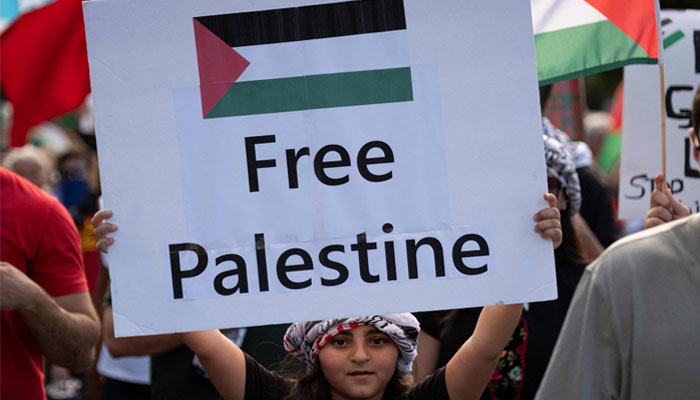 A girl holds a Free Palestine sign as people demonstrate in support of Palestinians in San Juan, Puerto Rico on October 17, 2023. — AFP