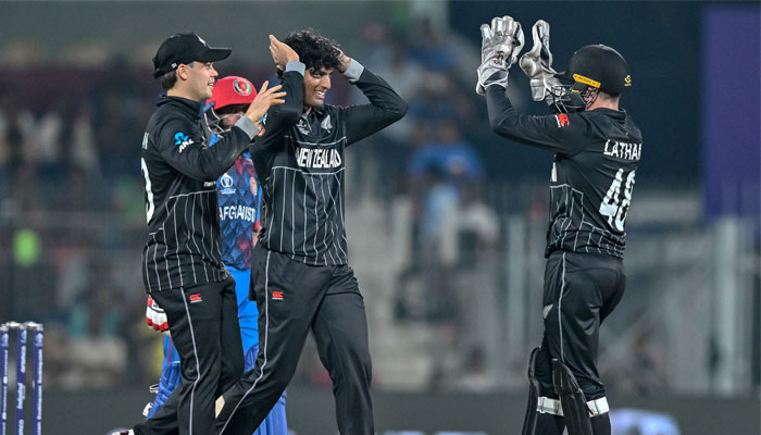 New Zealand´s Rachin Ravindra (centre) celebrates with teammates after taking the wicket of Afghanistan´s Rahmat Shah during the 2023 ICC Men´s Cricket World Cup match between New Zealand and Afghanistan at the MA Chidambaram Stadium in Chennai on October 18, 2023. — AFP