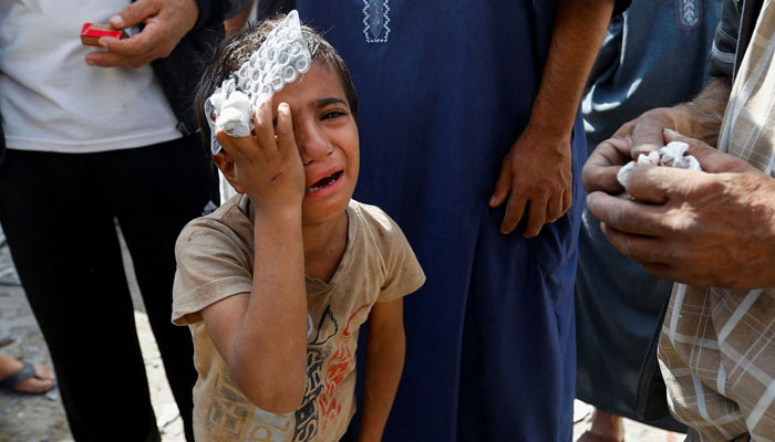 A Palestinian boy reacts at the site of Israeli strikes on houses, in Rafah in the southern Gaza Strip, October 17. — Reuters