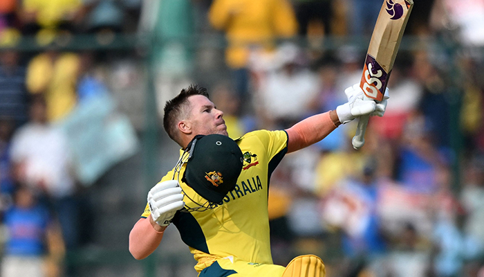 Australias David Warner celebrates after scoring a century (100 runs) during the 2023 ICC Men´s Cricket World Cup one-day international (ODI) match between Australia and Pakistan at the M. Chinnaswamy Stadium in Bengaluru on October 20, 2023. — AFP