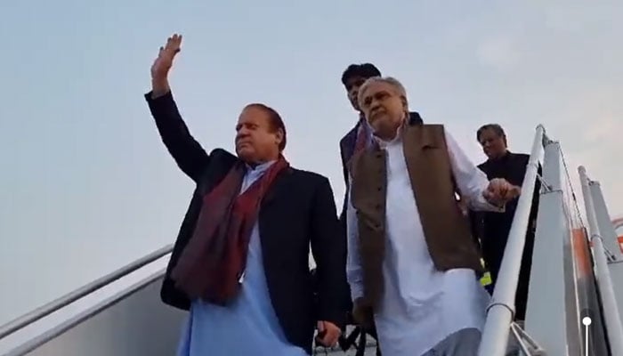 Pakistan Muslim League- Nawaz (PML-N) supremo Nawaz Sharif (left) and Ishaq Dars land in Islamabad on October 21, 2023, in this still taken from a video. — X/ @pmln_org