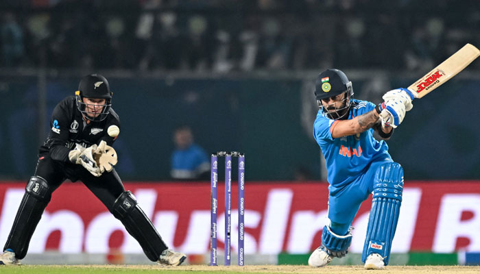 India’s Virat Kohli (R) plays a shot during the 2023 ICC Men’s Cricket World Cup one-day international (ODI) match between India and New Zealand at the Himachal Pradesh Cricket Association Stadium in Dharamsala on October 22, 2023. — AFP