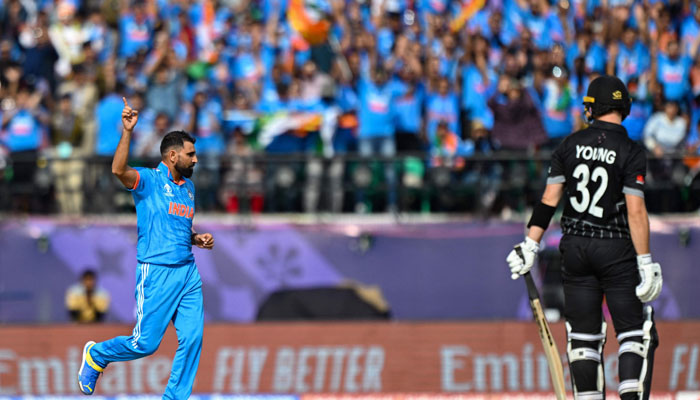 India´s Mohammed Shami celebrates after taking the wicket of New Zealand´s Will Young (R) during the 2023 ICC Men´s Cricket World Cup one-day international (ODI) match between India and New Zealand at the Himachal Pradesh Cricket Association Stadium in Dharamsala on October 22, 2023. — AFP