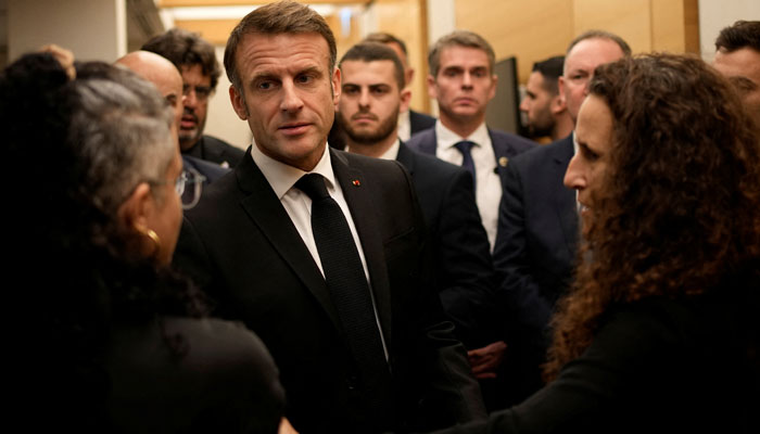 French President Emmanuel Macron meets with Israeli-French nationals who have lost loved ones, as well as families of hostages, at the Ben Gurion airport, Tuesday, Oct. 24, 2023 in Tel Aviv. — Reuters