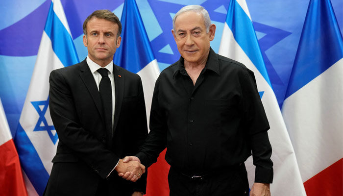 Israeli Prime Minister Benjamin Netanyahu, right, welcomes French President Emmanuel Macron before their talks in Jerusalem, Tuesday, Oct. 24, 2023. — Reuters