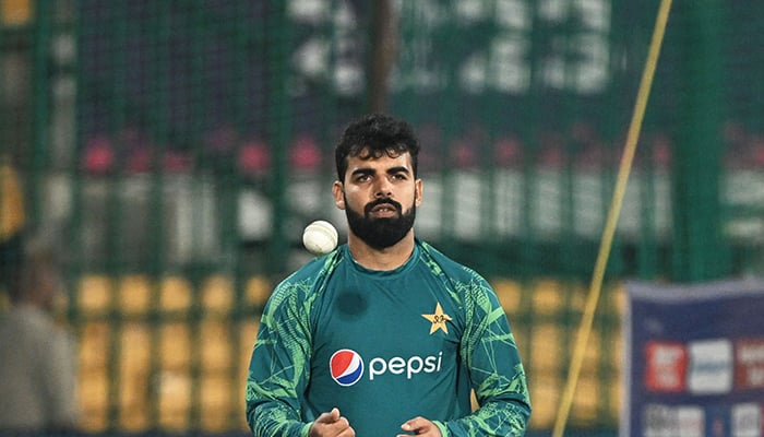 Pakistans Shadab Khan spins the ball during a practice session on the eve of the 2023 ICC Mens World Cup match between Pakistan and Australia at the M Chinnaswamy Stadium in Bengaluru on October 19, 2023. — AFP