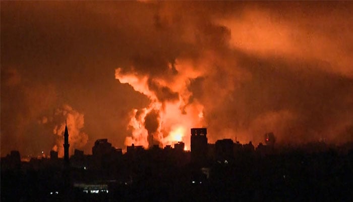 This image grab from an AFP TV footage shows balls of fire and smoke rising above Gaza City during an Israeli strike on October 27, 2023. — AFP