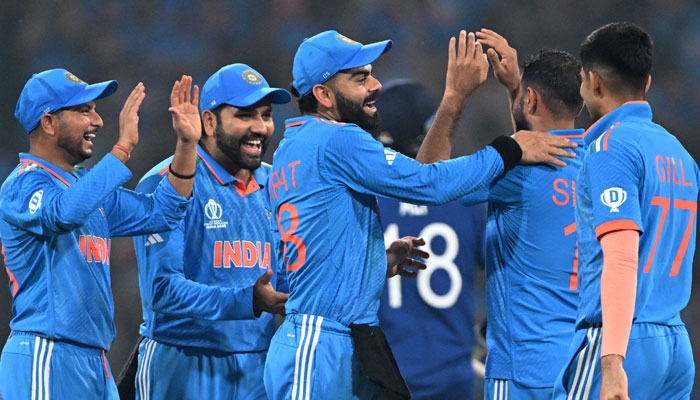 Indian players celebrate with teammates after taking the wicket of England´s Moeen Ali during the 2023 ICC Men´s Cricket World Cup match between India and England at the Ekana Cricket Stadium in Lucknow on October 29, 2023. — AFP