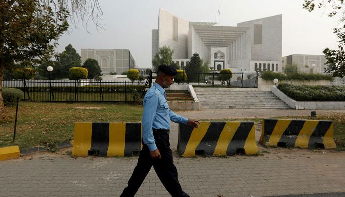 A policeman walks past the Supreme Court building in Islamabad, Pakistan October 31, 2018. — Reuters