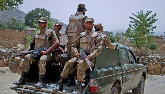 Security personnel tavelling in a military vehicle. — AFP/File