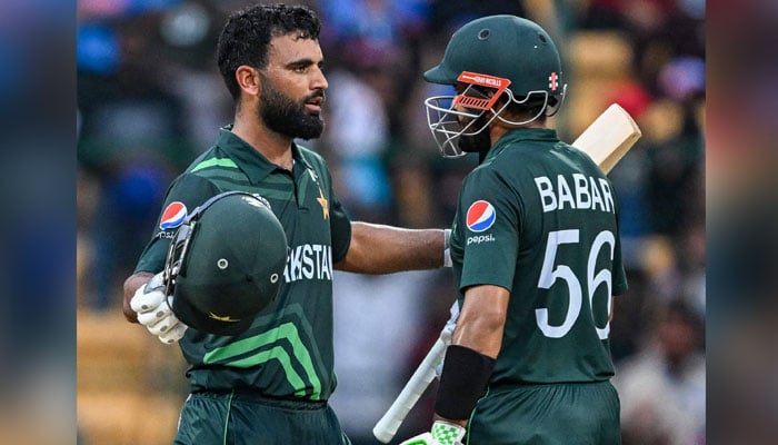 Pakistan’s Fakhar Zaman celebrates with his captain Babar Azam (R) after scoring a century (100 runs) during the 2023 ICC Men’s Cricket World Cup one-day international (ODI) match between New Zealand and Pakistan at the M. Chinnaswamy Stadium in Bengaluru on November 4, 2023. — AFP/File