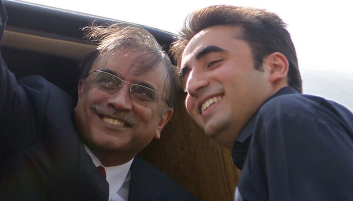 Asif Ali Zardari (left) and Bilawal Bhutto-Zardari are in a cheerful mood. — Reuters/File