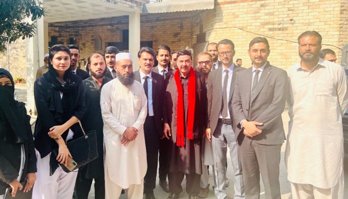 Awami Muslim League (AML) chief Sheikh Rashid Ahmed (centre) poses for a group photo with his lawyers and supports. — X/ @ShkhRasheed