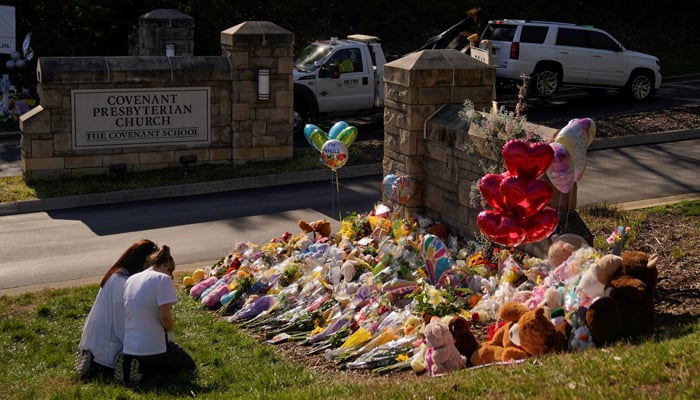 A vehicle is towed from the property as community members pray while visiting a memorial at the school entrance after a deadly shooting at the Covenant School in Nashville, Tennessee, US March 29, 2023. — Reuters