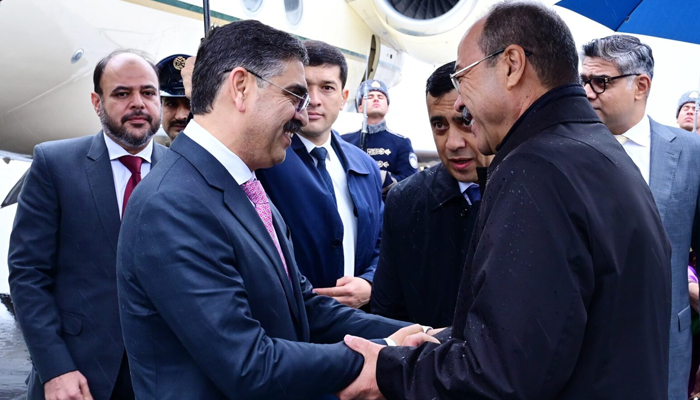 PM Anwaar-ul-Haq Kakar meets his Uzbek counterpart at Tashkent airport. — APP