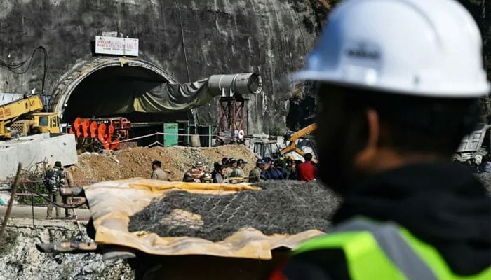 A rescue officer stands near the entrance to the Silkyara tunnel: engineers began digging on November 12 through some 57 metres (187 feet) of earth, concrete and rubble.—AFP