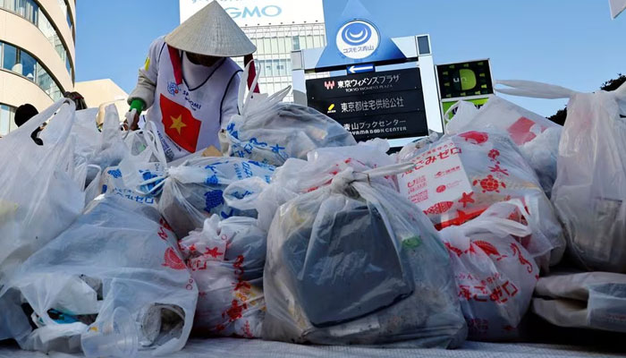 A member of team Vietnam puts garbage, which his team collected, on a collection point during a trash picking competition known as Spogomi World Cup in Tokyo, Japan November 22, 2023.—Reuters