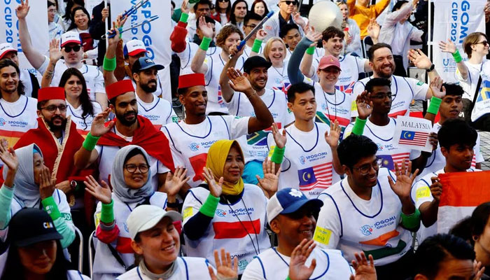 Participants wave hands at an opening ceremony during a trash picking competition known as Spogomi World Cup in Tokyo, Japan November 22, 2023. —Reuters