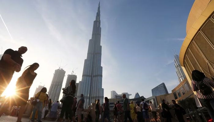 People are seen in front of Burj Khalifa, the worlds tallest building, in Dubai, United Arab Emirates March 12, 2020. — Reuters