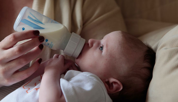 A representational image of an infant drinking baby formula. — Unsplash/File