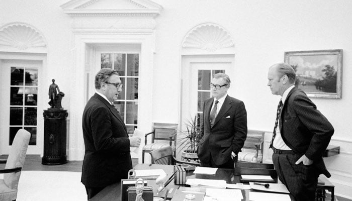 US President Gerald Ford, Nelson A Rockefeller and Henry A Kissinger stand around the Oval Office desk prior to walking to the Roosevelt Room for a National Security Council Meeting on the situation in South Vietnam, at the White House in Washington DC, US, April 28, 1975. — Gerald R Ford Library/Handout via Reuters
