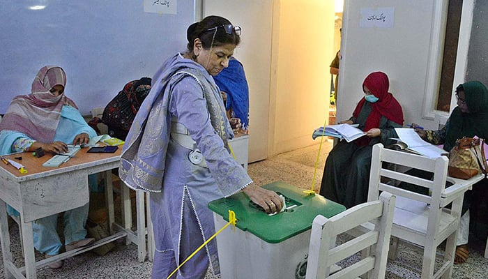A woman exercising her right to vote at a polling station in Karachi during an election on November 5, 2023. — APP