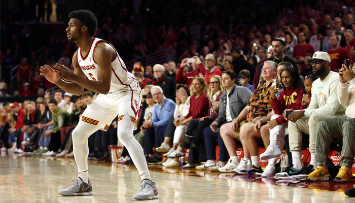 Bronny James #6 of the USC Trojans looks to catch the ball as LeBron James (R looks on ) from the stands during the first half against the Long Beach State 49ers at Galen Center on December 10, 2023, in Los Angeles, California, US. — AFP