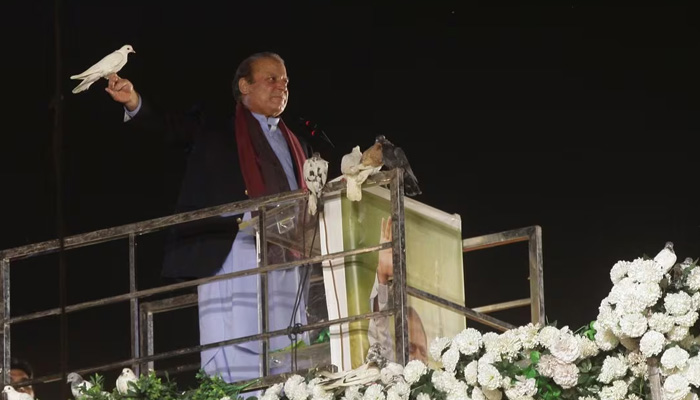 Former prime minister Nawaz Sharif prepares to release a pigeon in front of supporters, following his arrival from a self-imposed exile in London, ahead of the 2024 general election, in Lahore, October 21, 2023. — Reuters