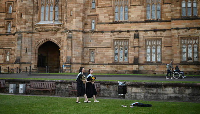 International students from China wear graduation gowns as they take pictures around the University of Sydneys campus after their in-person graduation ceremony was cancelled during the COVID-19 outbreak, in Sydney, Australia, July 4, 2020. — Reuters