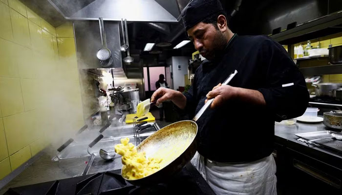 A cook prepares pasta Carbonara at La Carbonara restaurant in Campo de Fiori in Rome, Italy, December 14, 2023.—Reuters